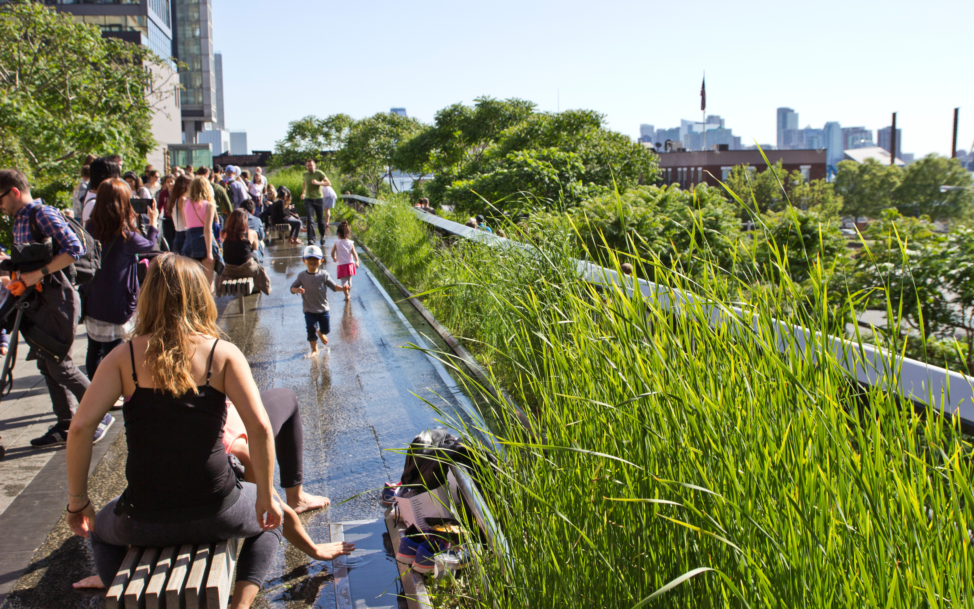 The concept also included water features. People sitting on benches and children playing with water